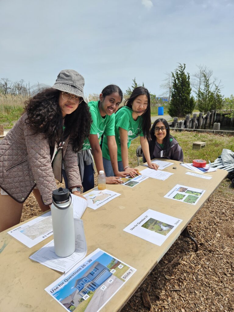 Kids outside around a table, participating in the envirothon