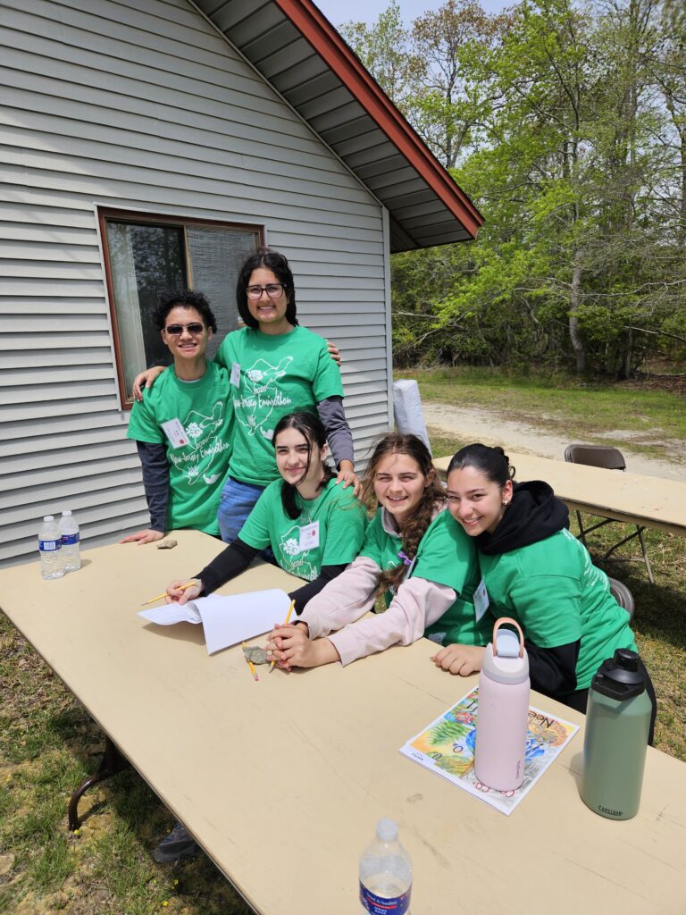 Kids outside around a table participating in envirothon