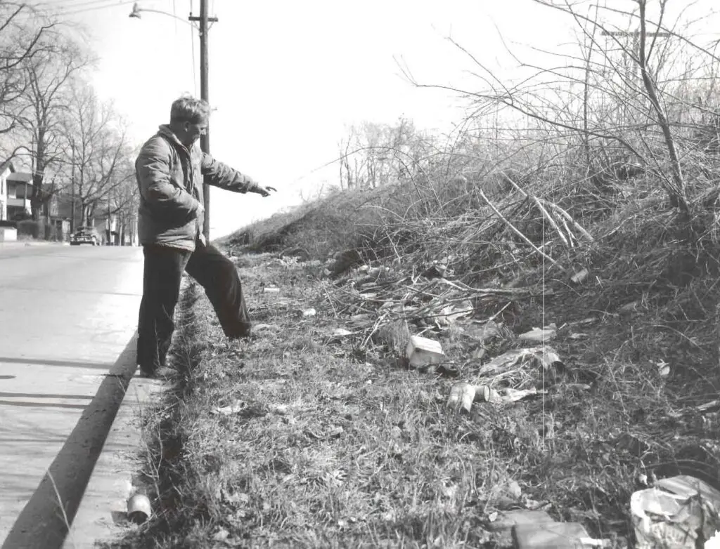 1962 Neal Munch pointing at ditch on Throckmorton St. Freehold
